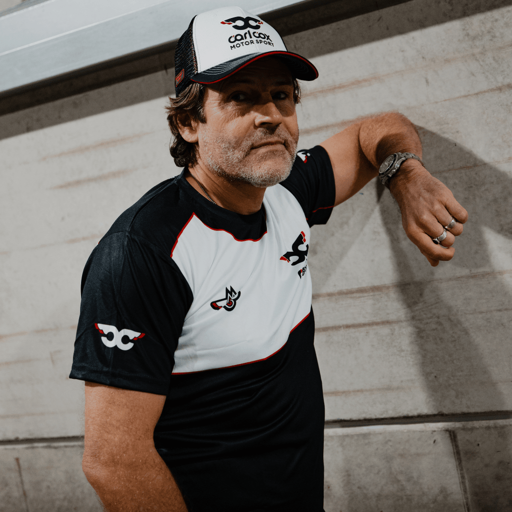 Uggly and Co Carl Cox Icon Trucker Hat, black trucker cap with DJ Carl Cox graphic, adjustable mesh back, casual style