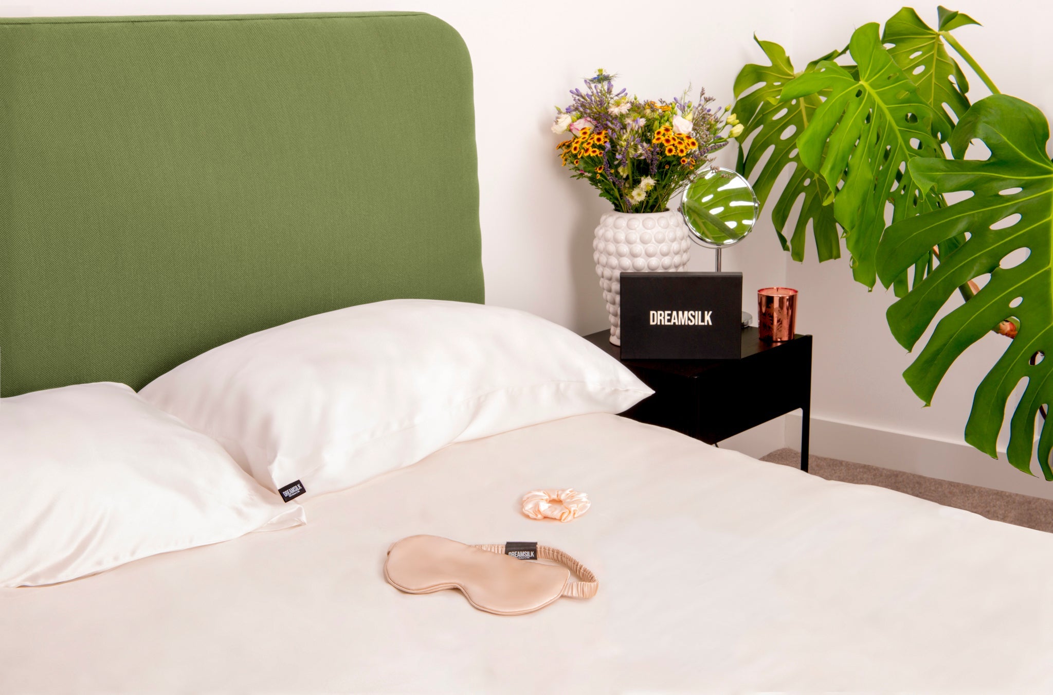 White silk pillowcase from DREAMSILK, standard size, smooth and shiny silk fabric with a soft, luxurious texture.