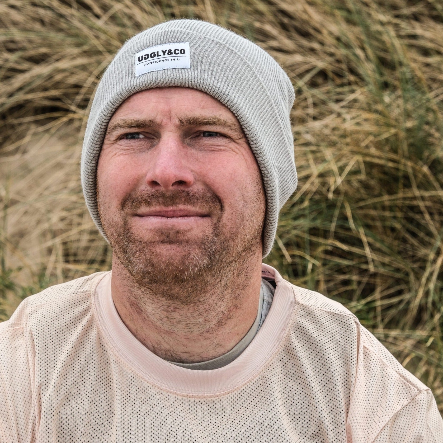 Grey Uggly and Co beanie, soft knitted winter hat with a snug fit, featuring a folded brim and cozy texture.