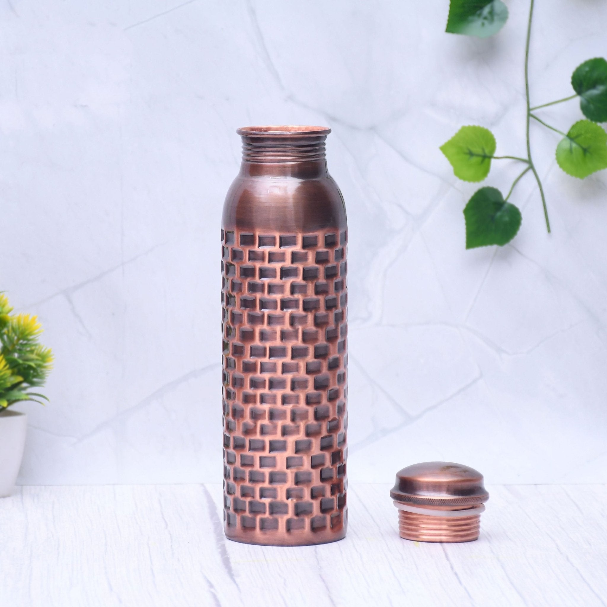 Pure copper water bottle with antique brick design, 1000ML capacity, featuring traditional craftsmanship and a sturdy handle.