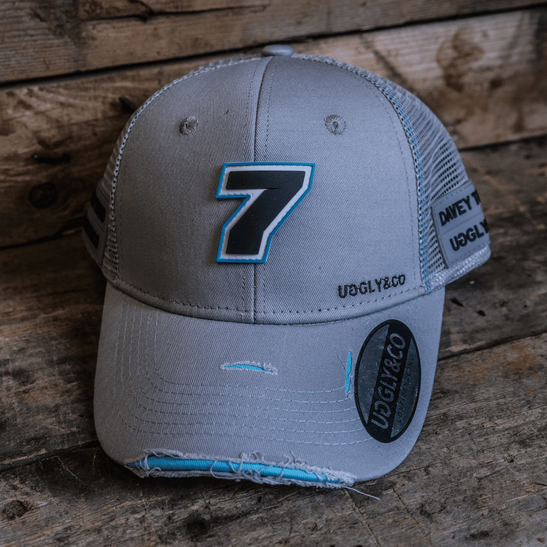 Steel grey Uggly and Co trucker cap featuring Davey Todd merchandise with a structured brim and adjustable snapback.
