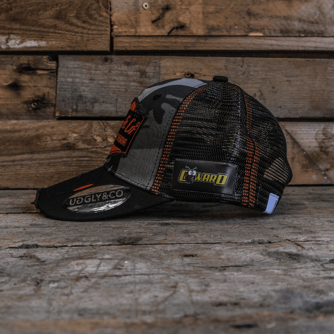 Grey camo diamond trucker cap by Uggly and Co featuring a mesh back and adjustable snap closure.