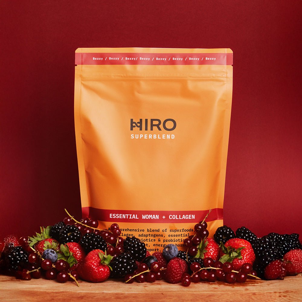 Hiro Essential Woman + Collagen superblend with mixed fruits, vibrant colorful blend in a clear glass jar.