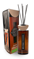 Musketeers Fresh Cut Grass reed diffuser with green botanical design, showcasing a sleek glass bottle and reed sticks for home fragrance