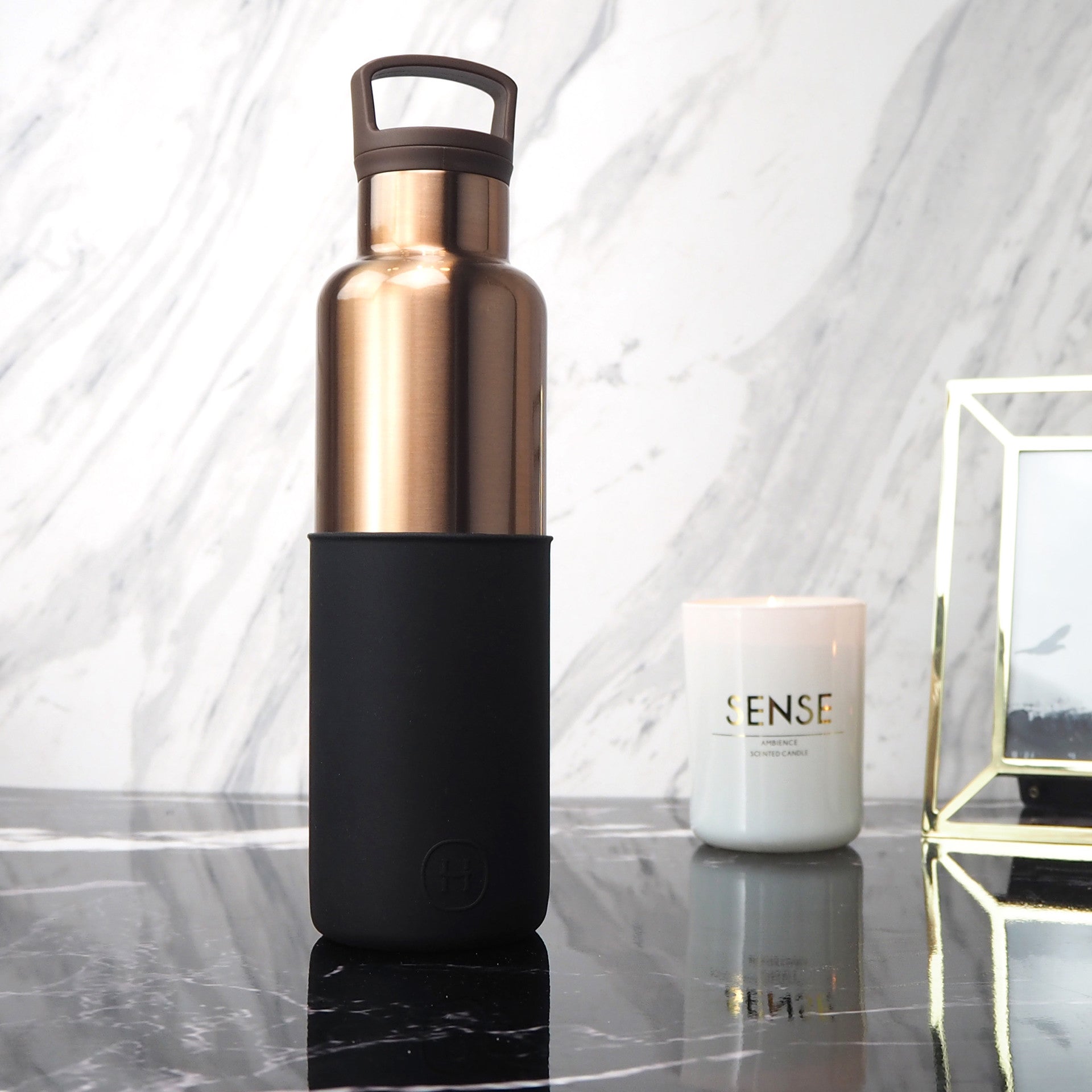HYDY 20 oz bronze, gold, and midnight black stainless steel bottle with a sleek design and secure lid.