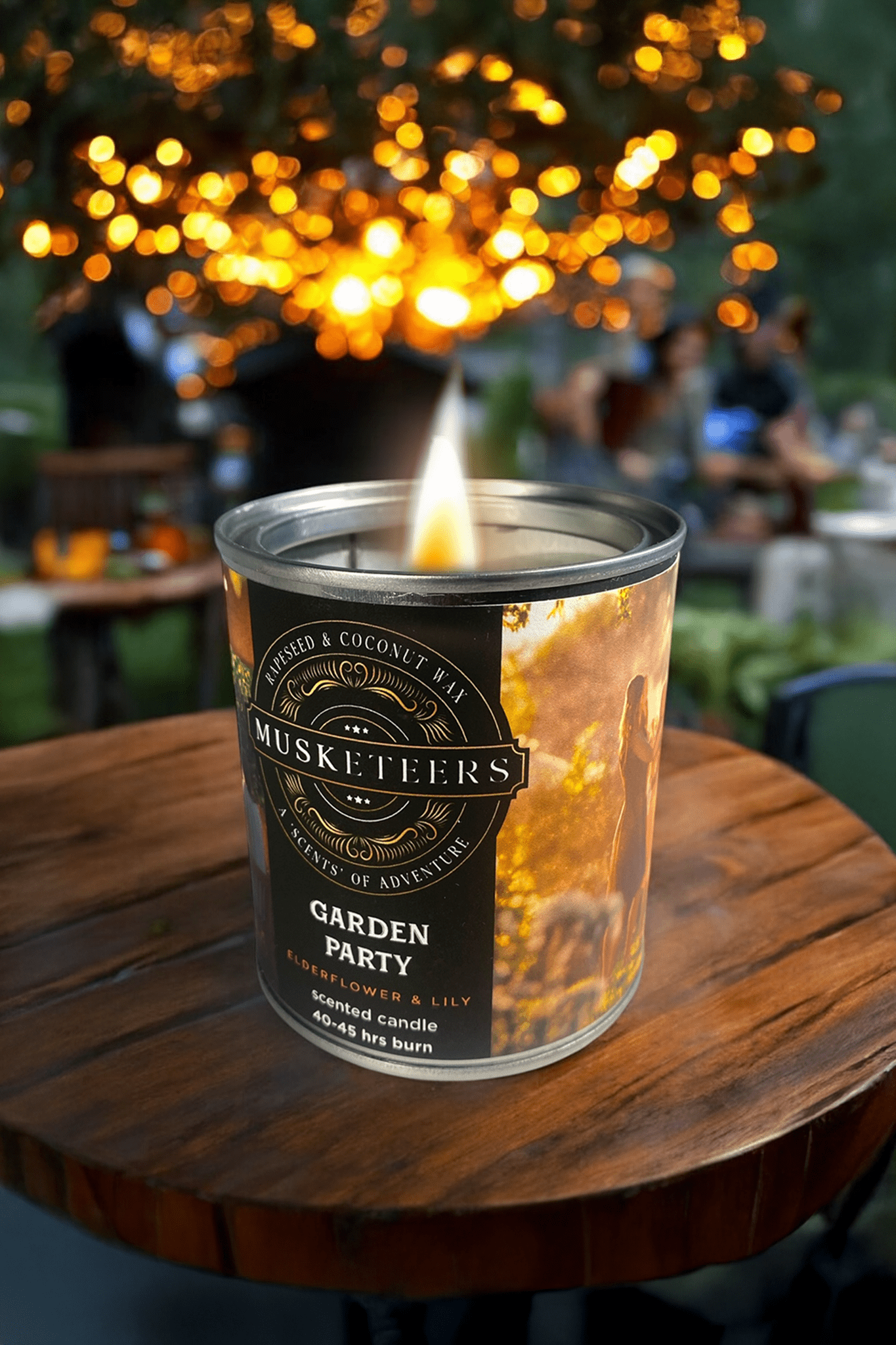 Elderflower and lily scented Musketeers Garden Party Candle with a decorative glass holder and floral design.