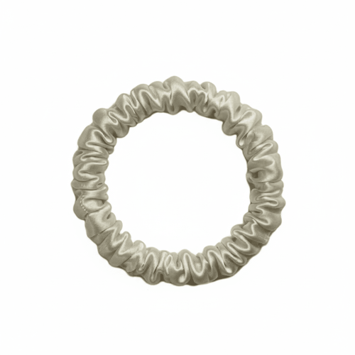 DREAMSILK champagne-colored silk scrunchie, skinny style, with smooth, shiny silk fabric for gentle hair hold and elegant look.