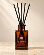 Bro Candle Gladiator reed diffuser with amber-colored reeds and glass bottle, designed for home fragrance.