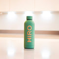 Green HIRO accessory bottle with a sleek design, featuring a vibrant green color and modern style.