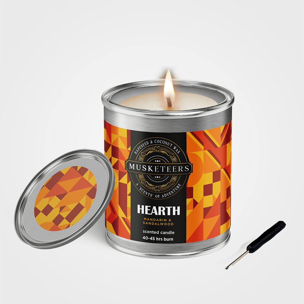 Musketeers Hearth Sandalwood Candle with Mandarin and Sandalwood scent, showing a lit masculine candle in a glass holder.