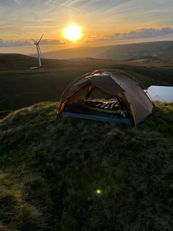 HikeWare Night Cat 2-person backpacking tent with aluminium poles, shown set up outdoors with rainfly and mesh windows.
