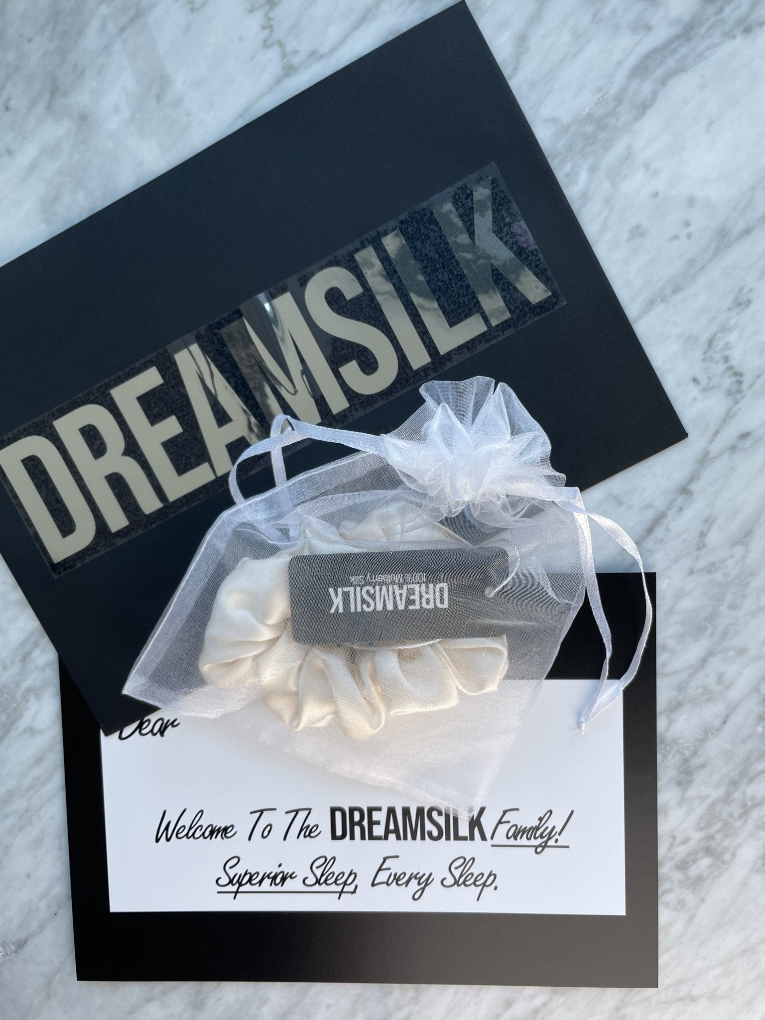 DREAMSILK champagne silk scrunchie, regular size, soft and smooth fabric, shown in a close-up image highlighting its elegant design.