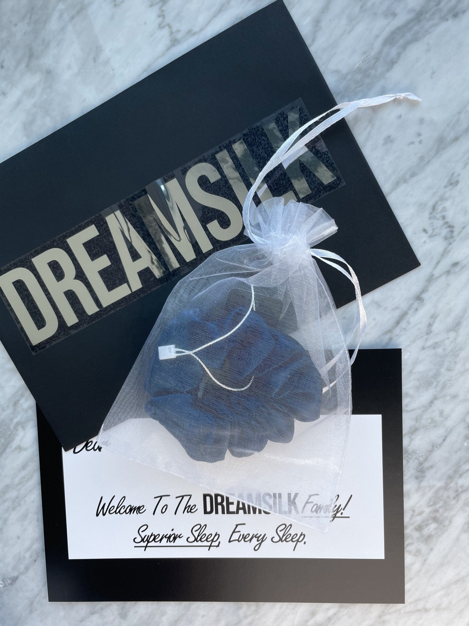 Navy blue silk scrunchie from DREAMSILK, regular size, soft and shiny silk fabric for gentle hair holding and elegant style.