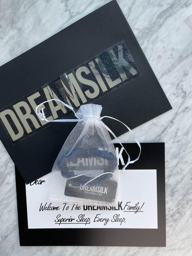 Navy blue silk skinny scrunchie from DREAMSILK with smooth, shiny fabric for gentle hair styling.