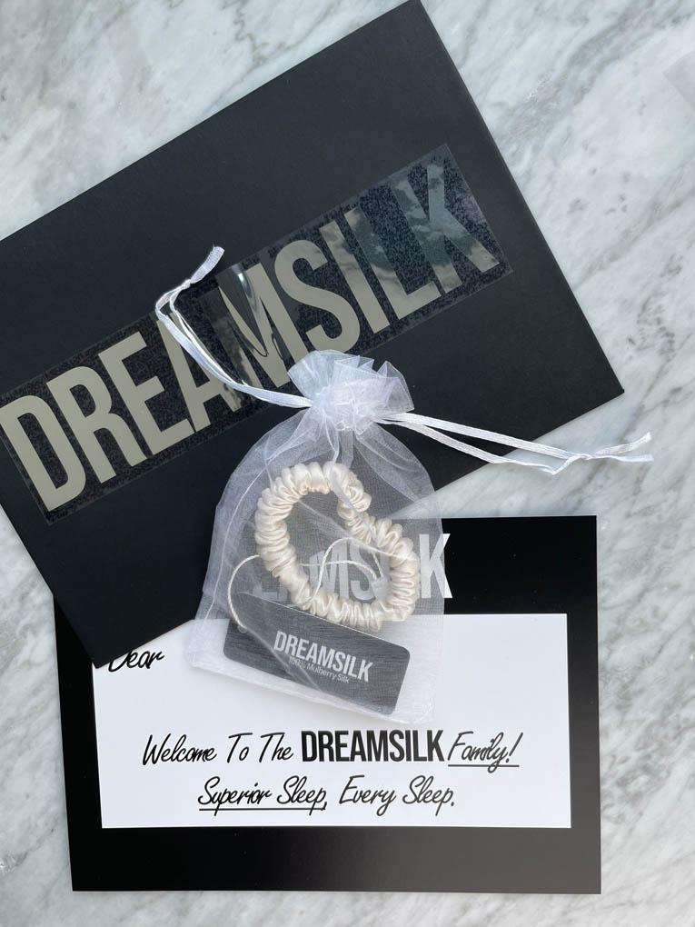 DREAMSILK Champagne silk skinny scrunchie with smooth, shiny fabric, ideal for gentle hair styling and elegant accessories.