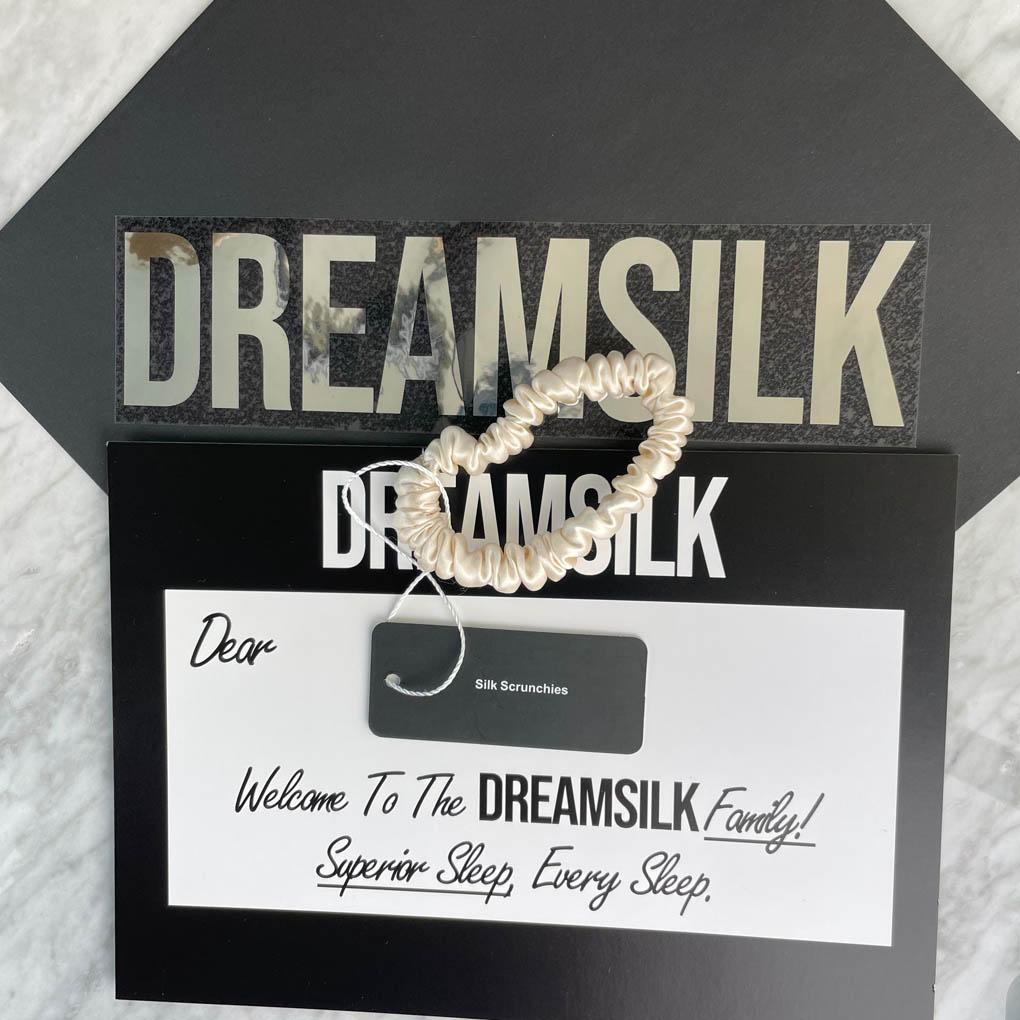 DREAMSILK champagne silk scrunchie, skinny style, made of smooth shiny silk suitable for hair accessories.