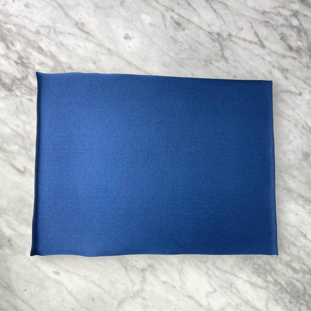 Navy blue silk pillowcase by DREAMSILK, standard size, smooth and luxurious fabric, close-up view showing soft silk texture.