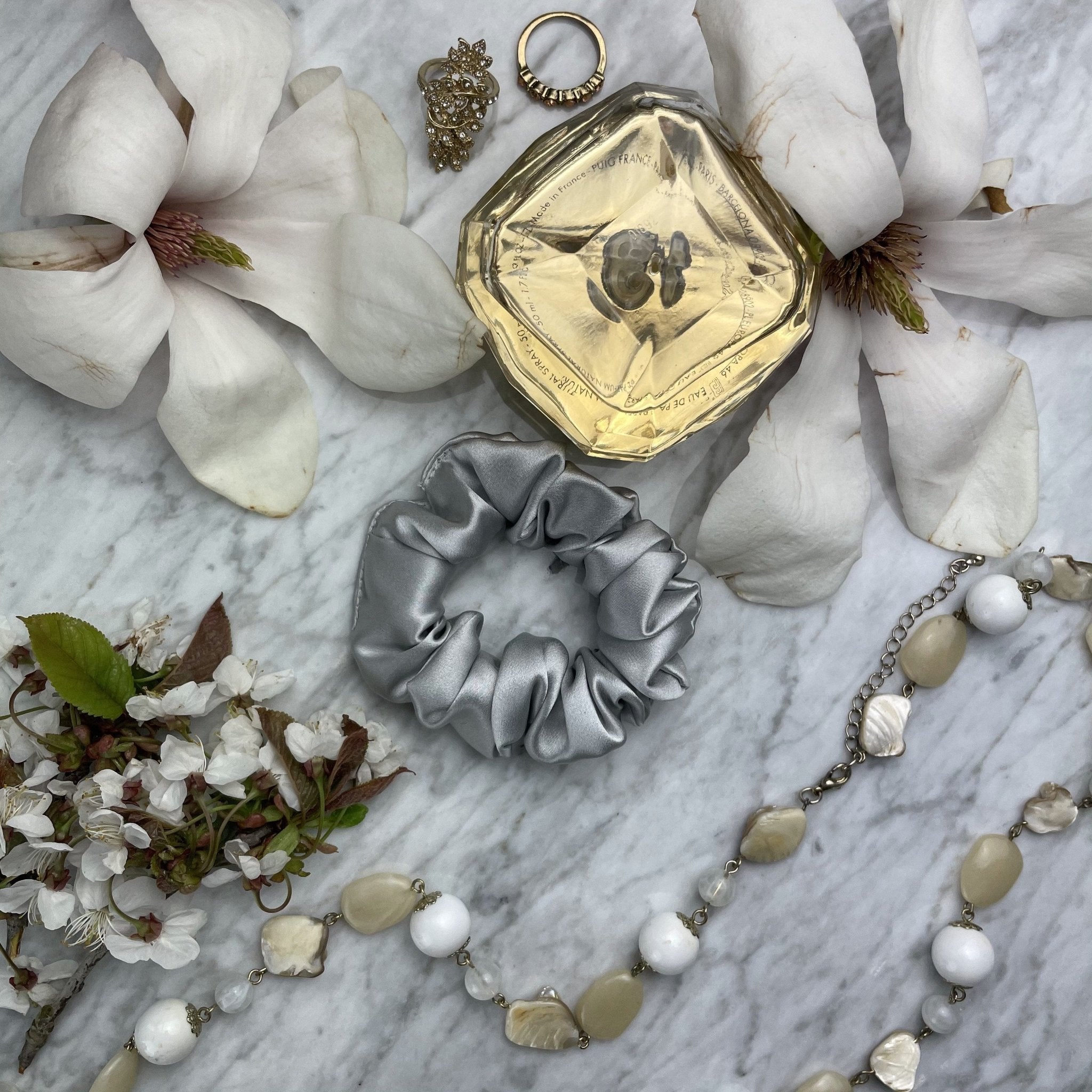 Silver silk scrunchie from DREAMSILK, regular size, soft and shiny silk fabric with a comfortable elastic band.