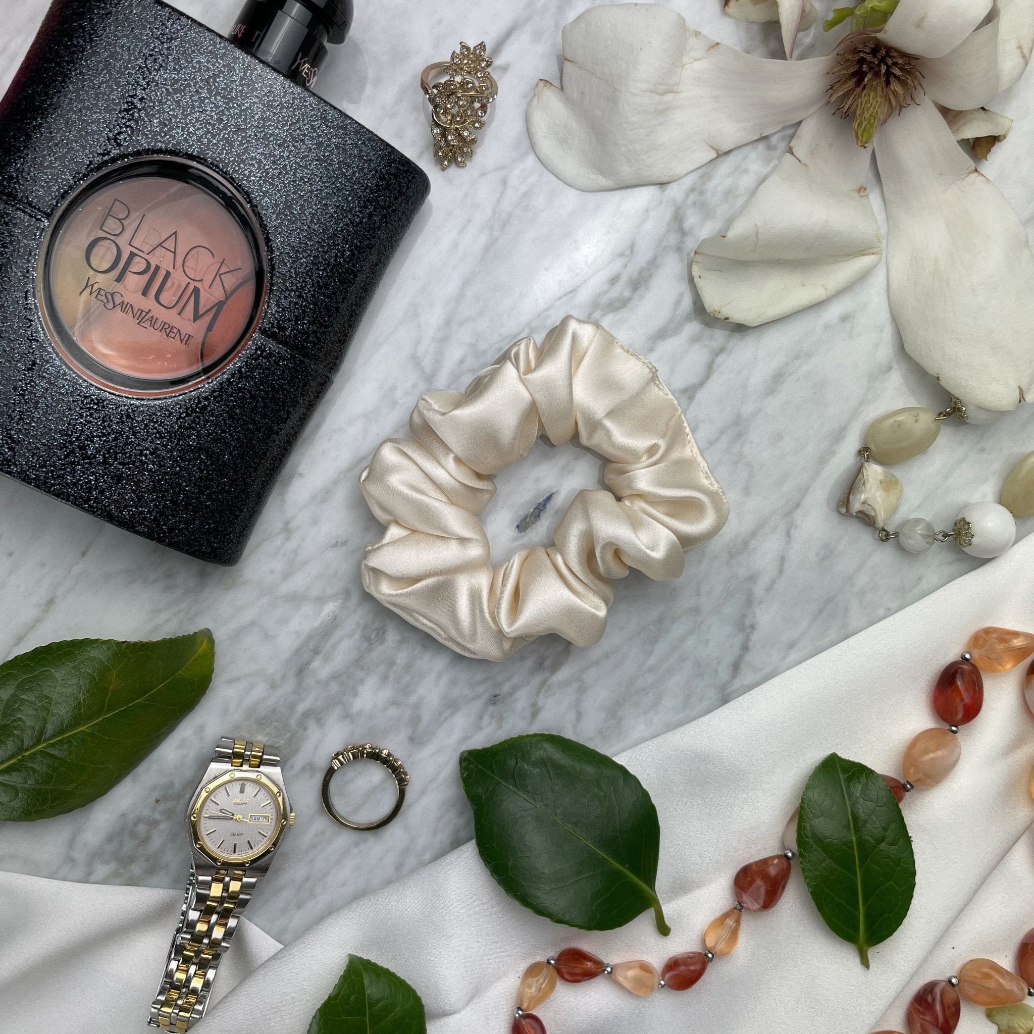 Champagne silk scrunchie by DREAMSILK showing a smooth, shiny silk hair accessory in a neutral champagne color.
