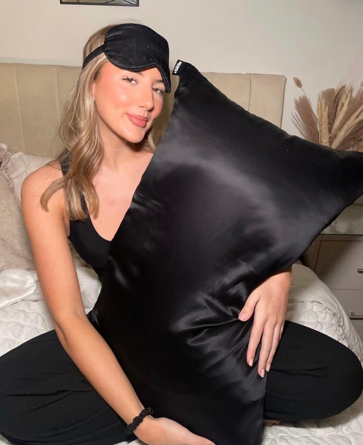 Luxury DREAMSILK silk pillowcase with smooth, shiny fabric and elegant stitching, showcasing its soft and luxurious texture.