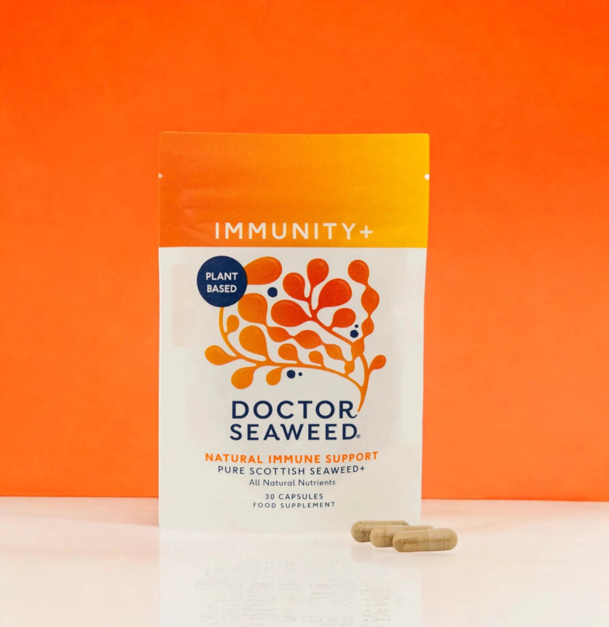 Doctor Seaweed Immunity+ supplement bottle with label and capsules on a plain background.