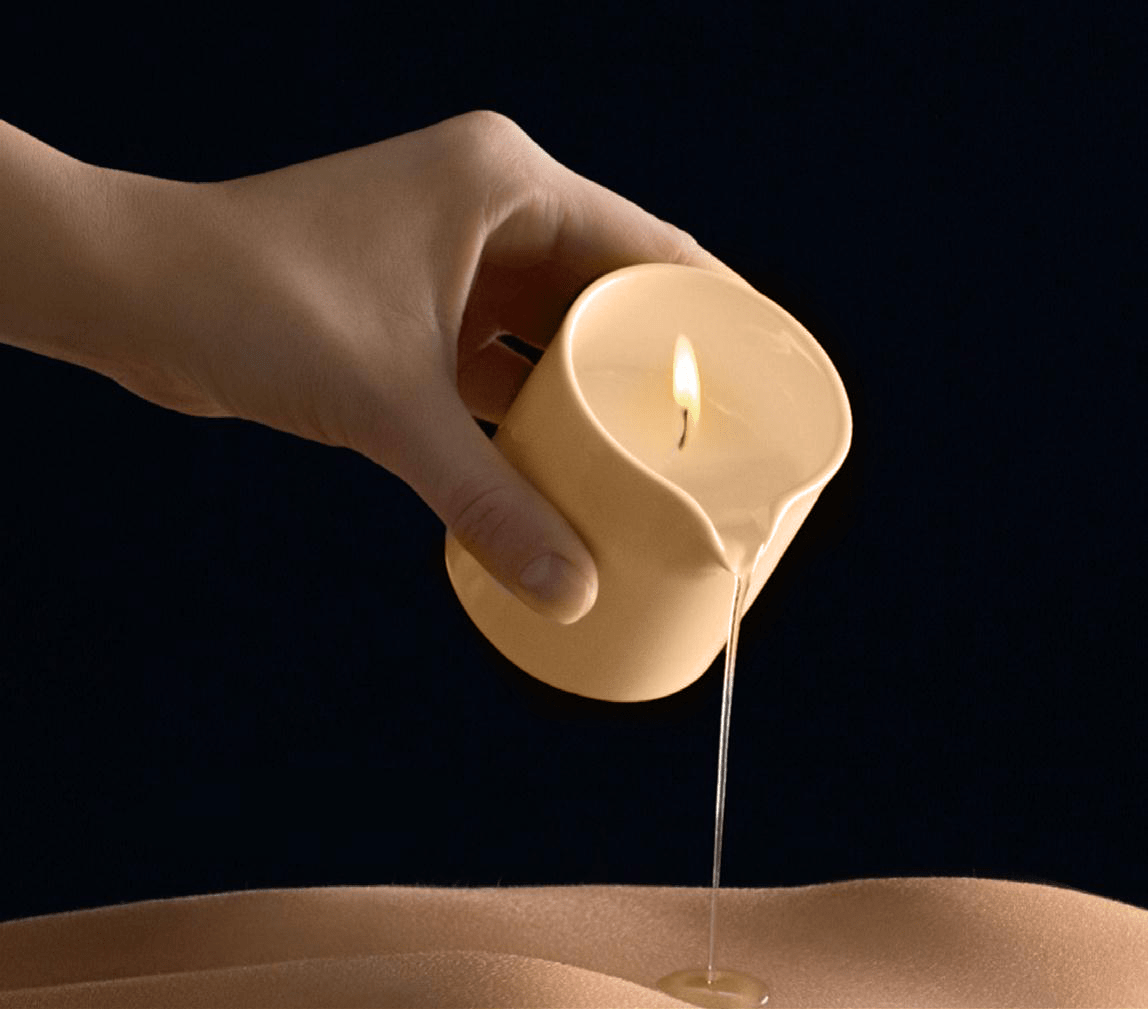 Scented massage candle by Musketeers with mandarin and sandalwood, melting to create warm, aromatic massage oil.