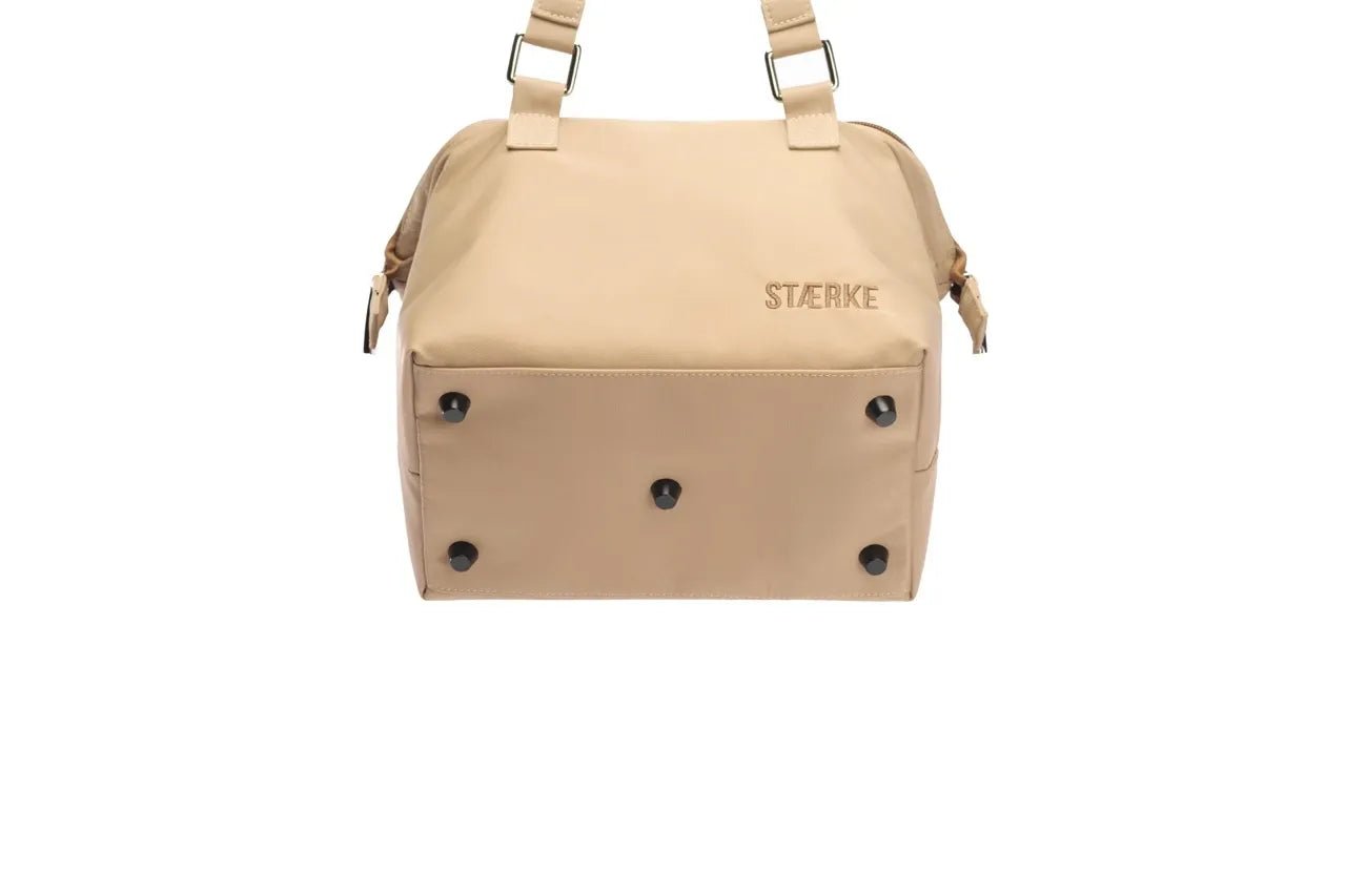 Mini gym bag by STÆRKE with a compact design, featuring a zippered main compartment and adjustable shoulder strap.