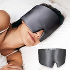Black silk sleep mask by DREAMSILK with soft padding, blocking light for restful sleep and eye comfort.