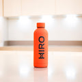 Orange bottle accessory from HIRO's The Orange One collection, featuring a vibrant orange design and sleek shape.