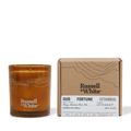 Russell + White Oud Fortune scented soy candle in 250g jar with warm amber-colored wax and elegant label design.
