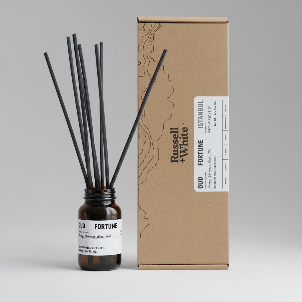 Russell + White Oud Fortune 100ml reed diffuser with black and gold bottle and natural reed sticks for home fragrance.
