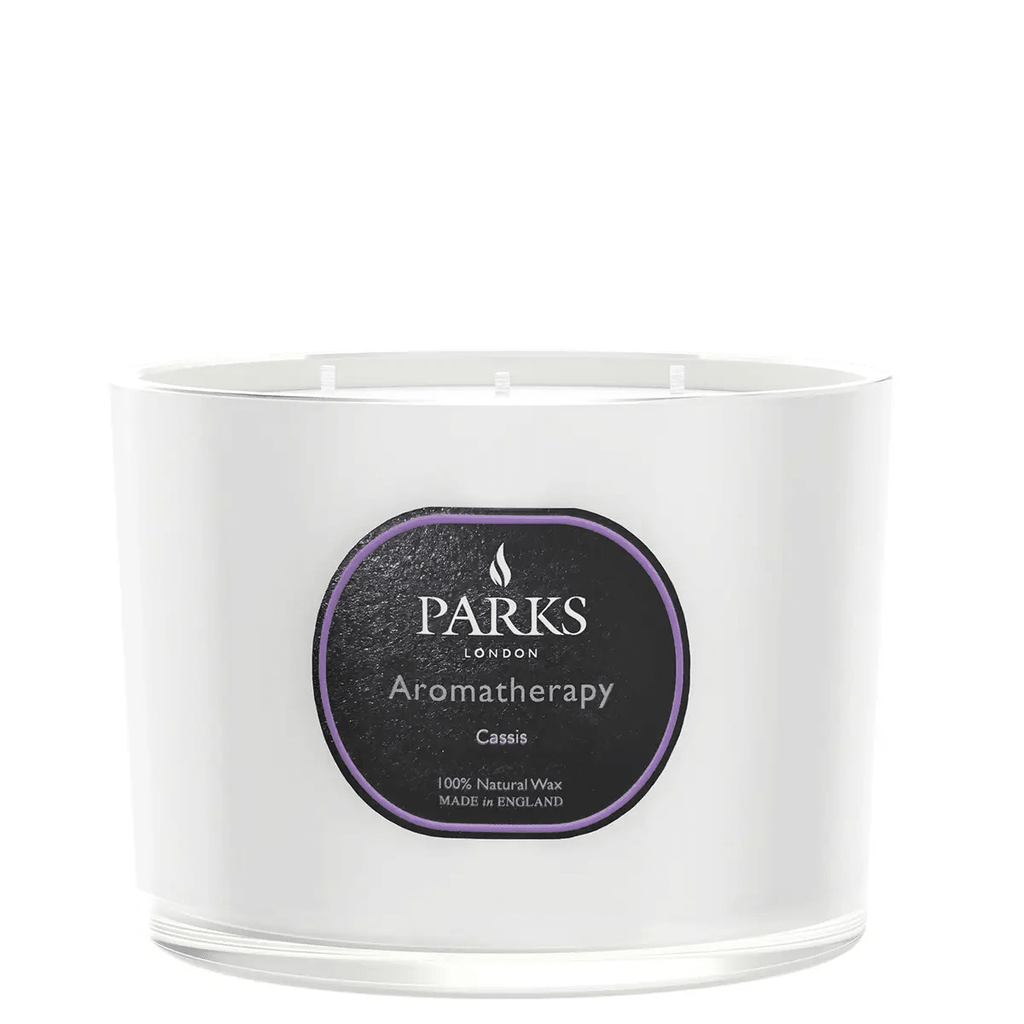 Parks Candles Cassis 3-wick candle in 350g glass jar with a floral purple and white label and three burning wicks.
