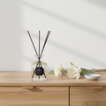 Reed diffuser by Parks Candles featuring Tuberose and Ylang Ylang scent in a 100ml glass bottle with reed sticks.