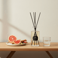 Parks Candles reed diffuser with rhubarb and pink grapefruit scent in a 220ml glass bottle, featuring reed sticks for fragrance diffusion.
