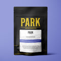 A bag of Park House Blend roasted coffee by Park Coffee, showing the label with a rich coffee bean design on the packaging.
