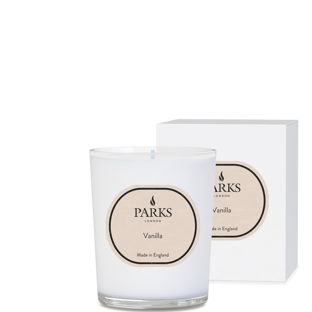 Parks Candles vanilla scented candle in 180g glass jar with a lit wick, showcasing a warm, inviting glow.