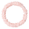 Pink silk skinny scrunchie by DREAMSILK, soft and smooth hair accessory with a sleek, slender design for gentle hold.