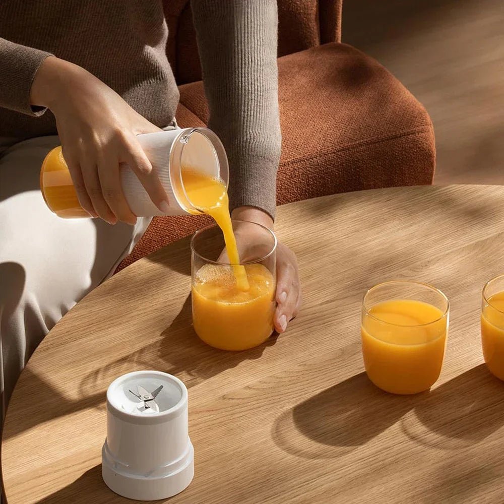 Mijia portable juicer cup with rechargeable battery, compact fruit blender with clear blending container and lid.