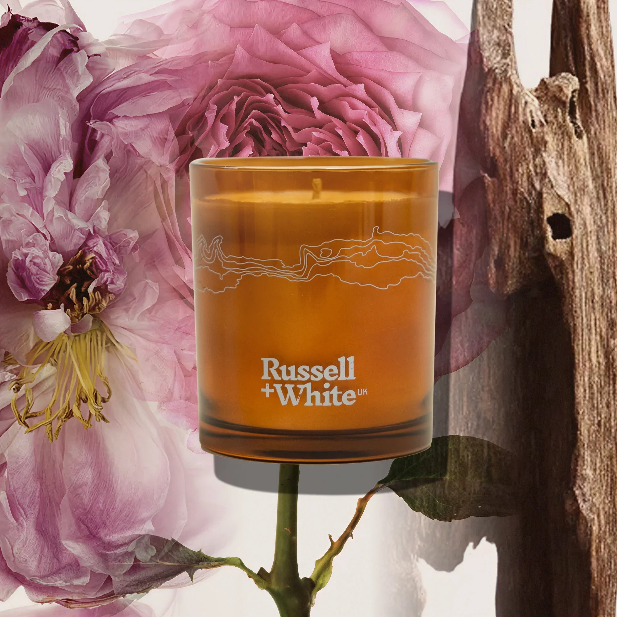 Russell + White Oud Fortune 250g scented soy candle with elegant packaging and a warm, inviting candle wick.