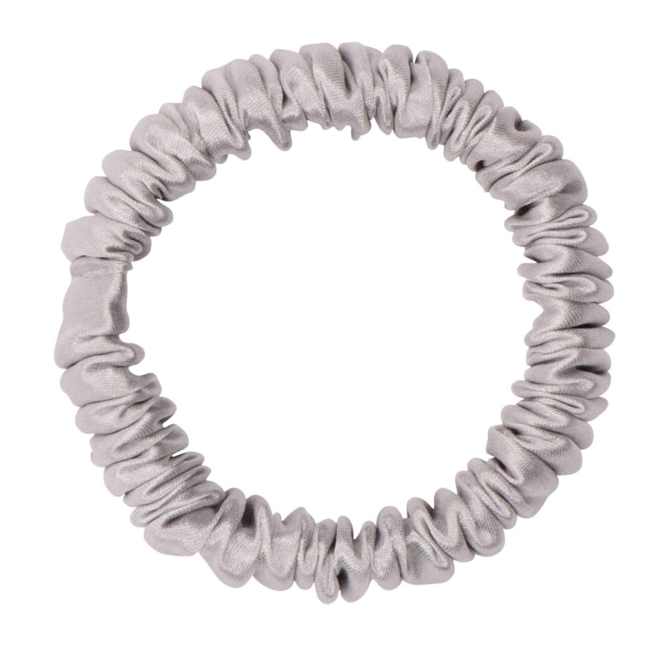 Silver silk skinny scrunchie from DREAMSILK, soft and shiny silk fabric with a slim design, shown on a white background.