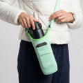 Green ION8 sling bottle bag from Xtras & Add-Ons collection, lightweight and compact for carrying beverages easily.