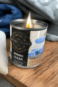 Musketeers Spring Clean Candle with cotton and fresh linen scent, featuring a white wax candle in a glass jar.