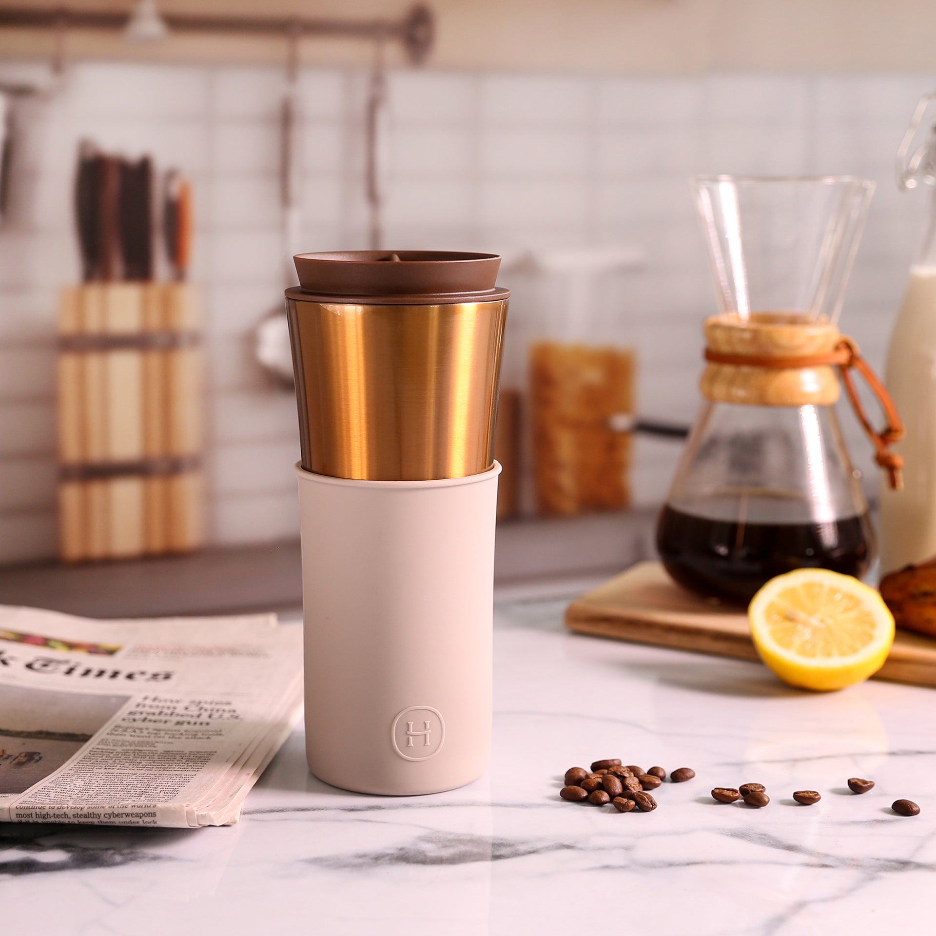 Bronze gold HYDY travel mug with eucalyptus design, 15 oz stainless steel insulated coffee tumbler, front view.