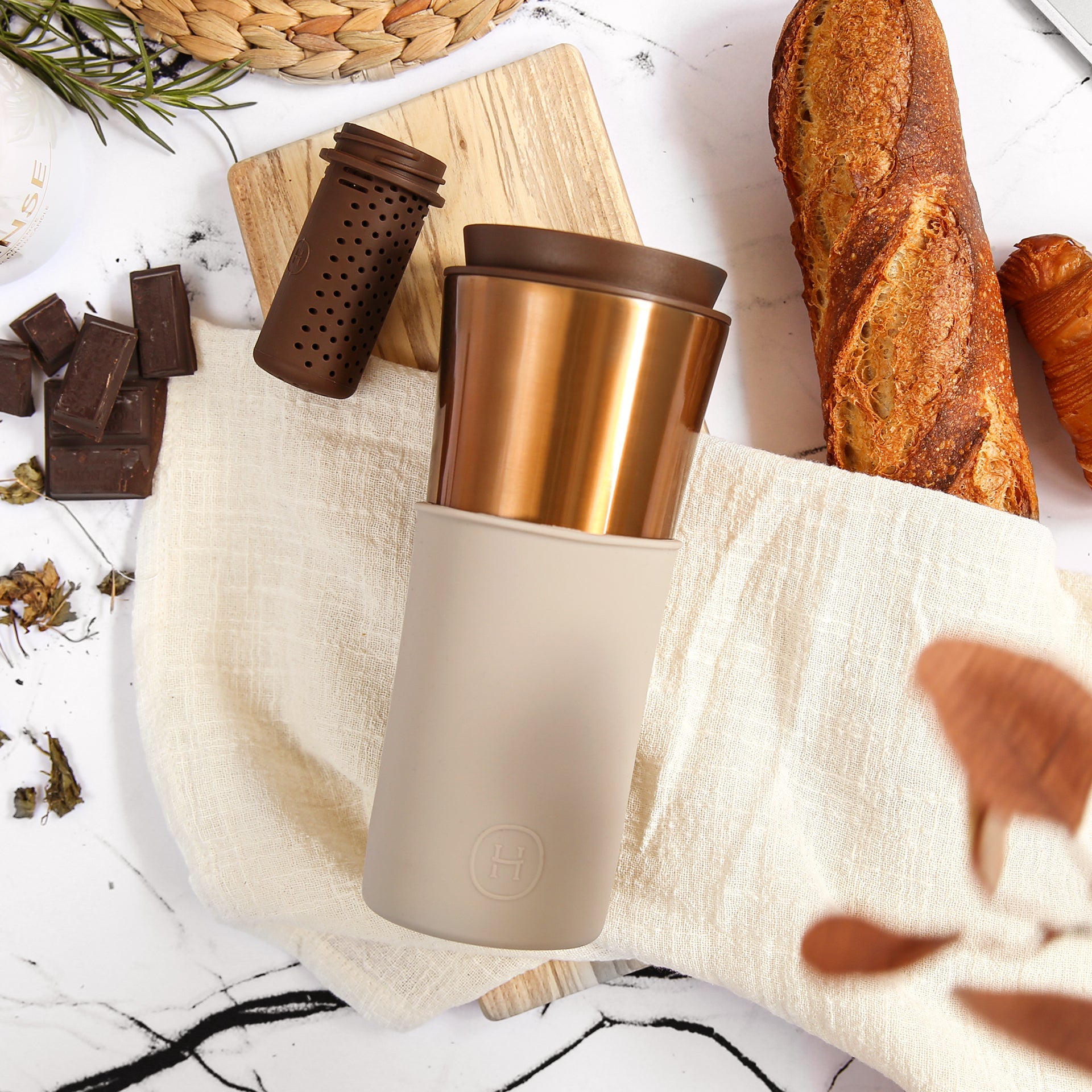 Bronze gold Eucalyptus travel mug by HYDY, 15 oz stainless steel mug with a sleek design and secure lid for on-the-go drinking.