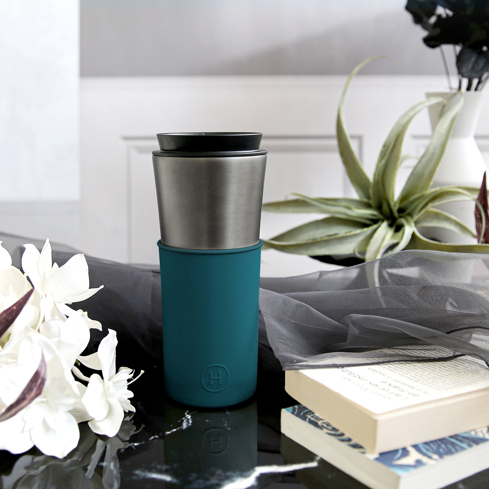 Titanium grey and peacock green HYDY travel mug, 15 oz, with a sleek stainless steel design and secure lid for on-the-go use.