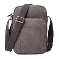Black Troop London across body bag with adjustable strap and multiple compartments, displayed on a plain background.