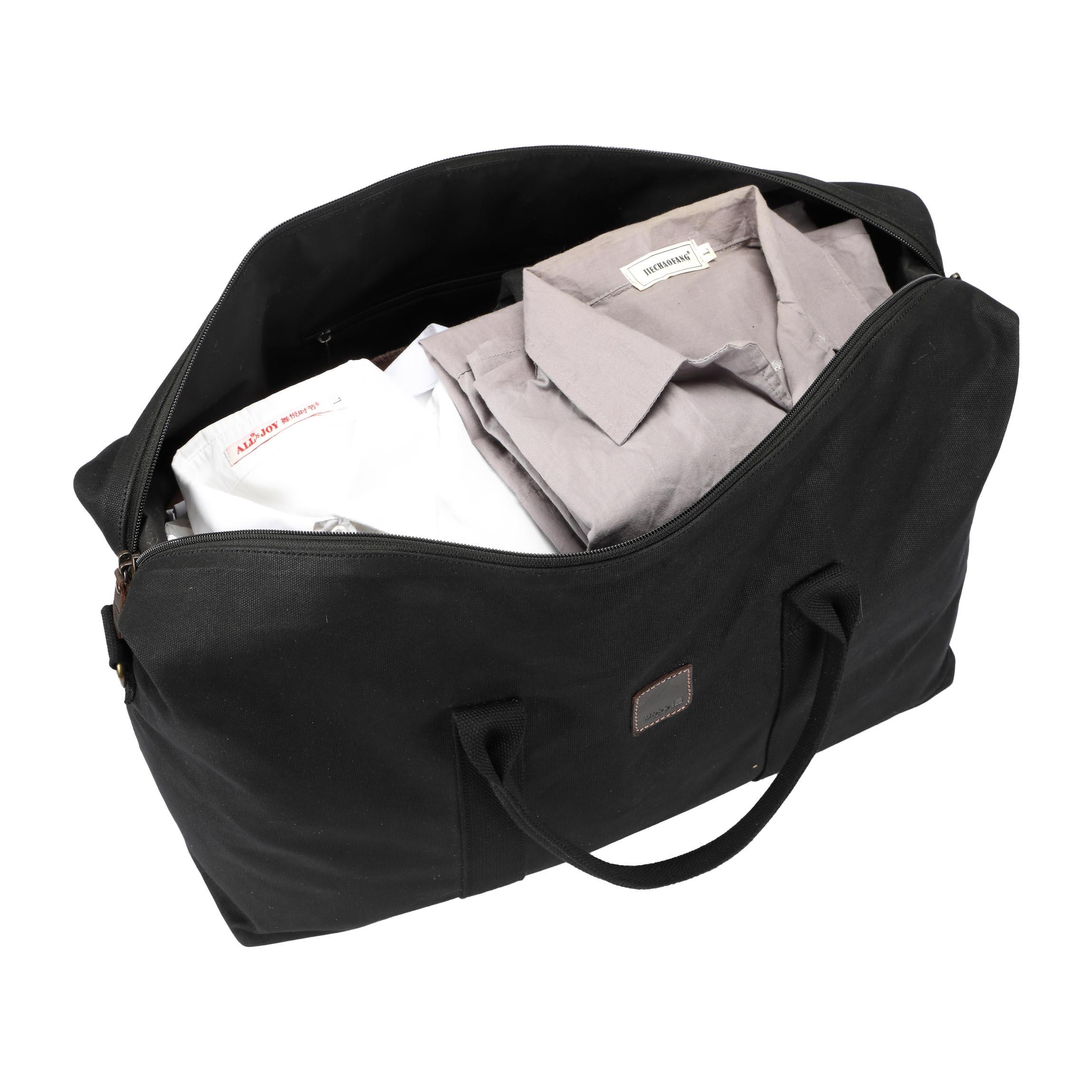 Large black Troop London Heritage Holdall with leather handles and multiple compartments, ideal for travel and everyday use.