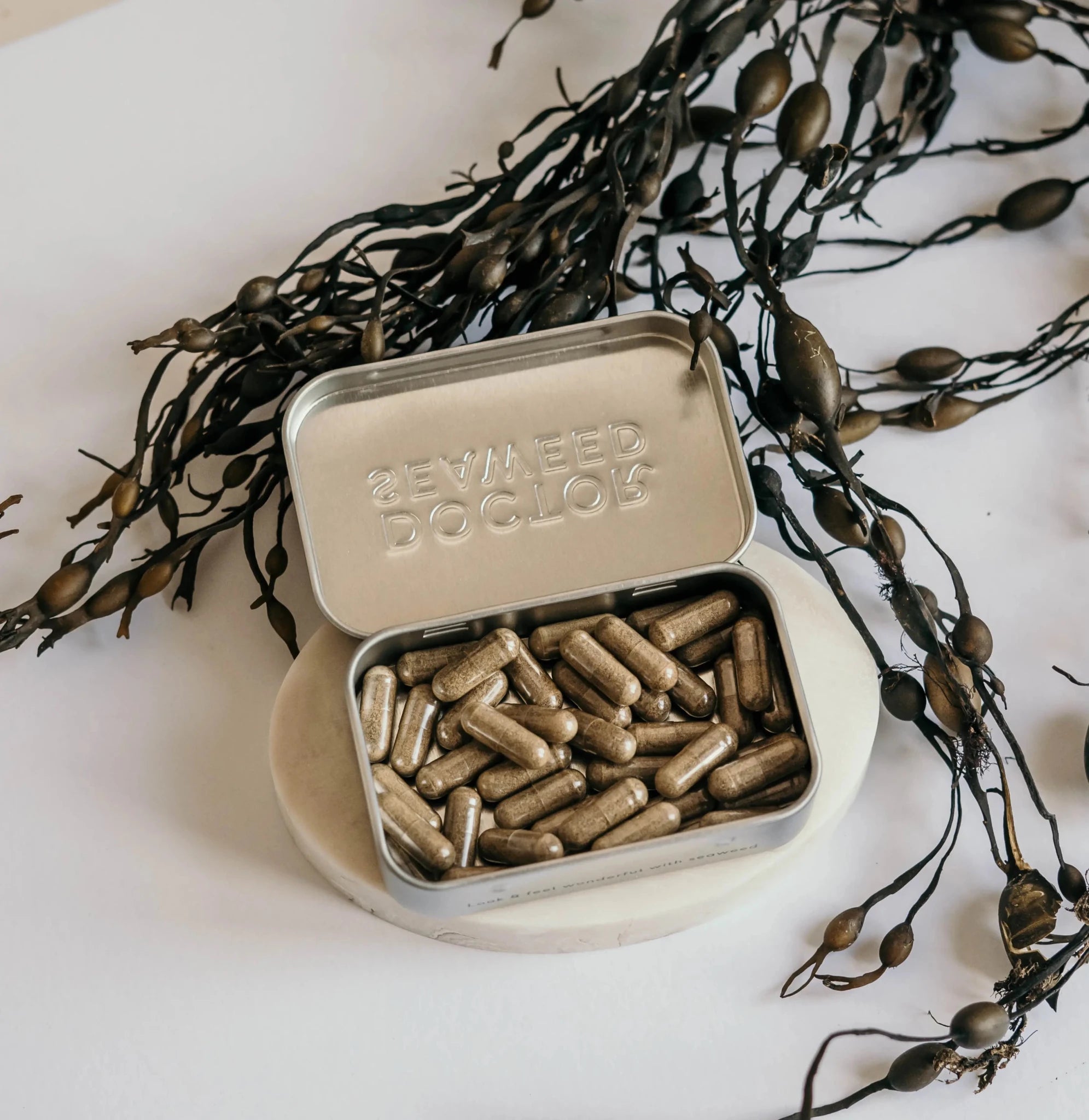 Refillable supplement tin by Doctor Seaweed with a metal lid and compact design, suitable for storing dietary supplements or herbs.