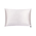 White silk pillowcase from DREAMSILK, standard size, smooth and luxurious fabric, displayed on a bed with soft lighting