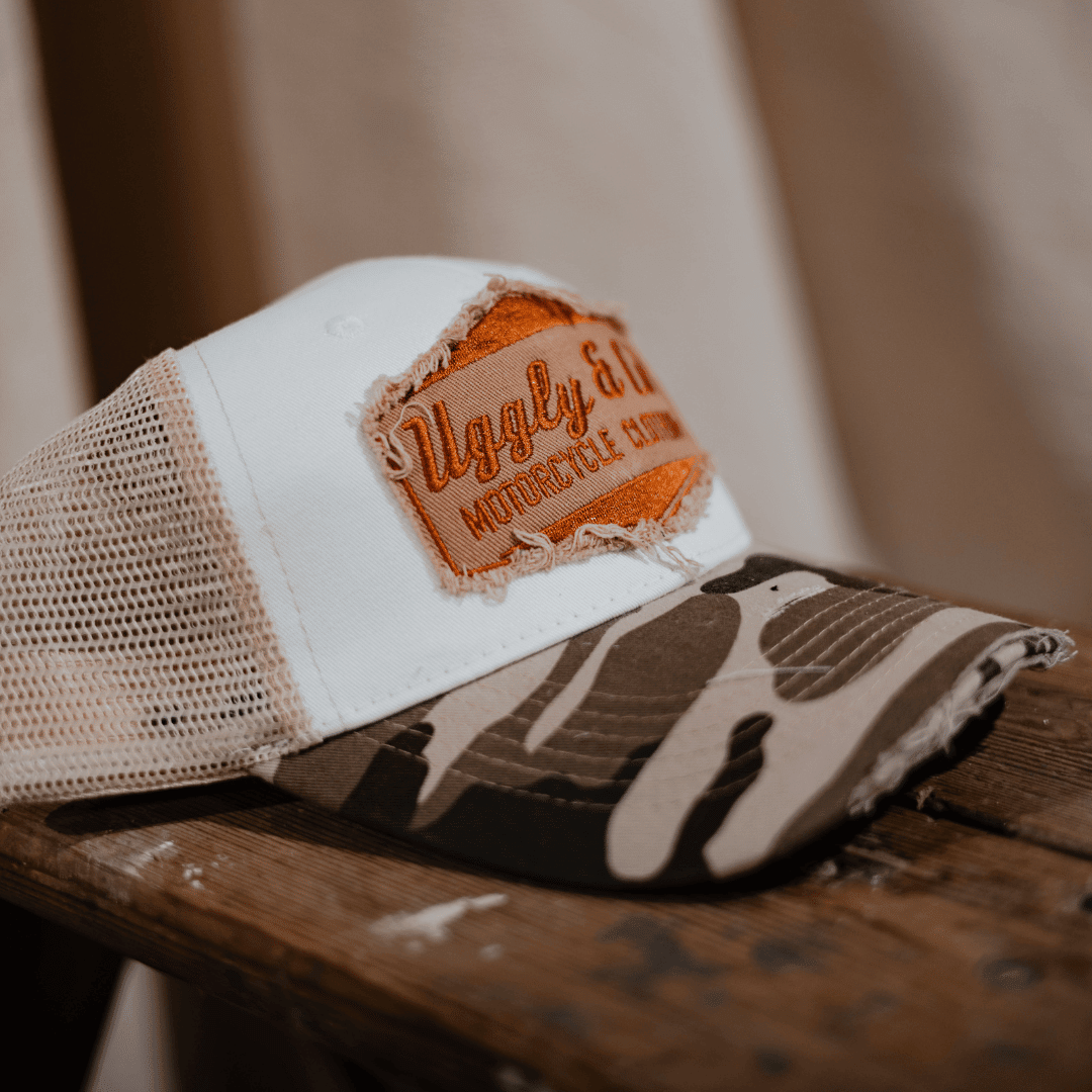 Vintage camouflage diamond trucker hat by Uggly and Co with mesh back and curved brim.